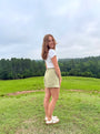 Lincoln Paris sage linen shorts displayed on a model, featuring a relaxed fit and casual summer style.