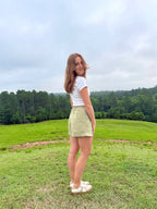 Lincoln Paris sage linen shorts displayed on a model, featuring a relaxed fit and casual summer style.