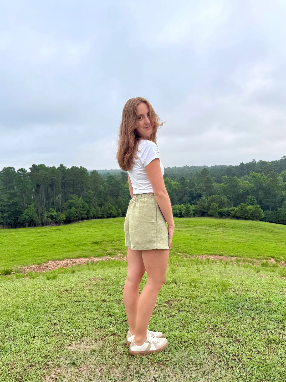 Lincoln Paris sage linen shorts displayed on a model, featuring a relaxed fit and casual summer style.
