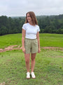 Lincoln Paris sage linen shorts displayed on a model, showcasing lightweight, breathable fabric and relaxed fit for casual summer wear.