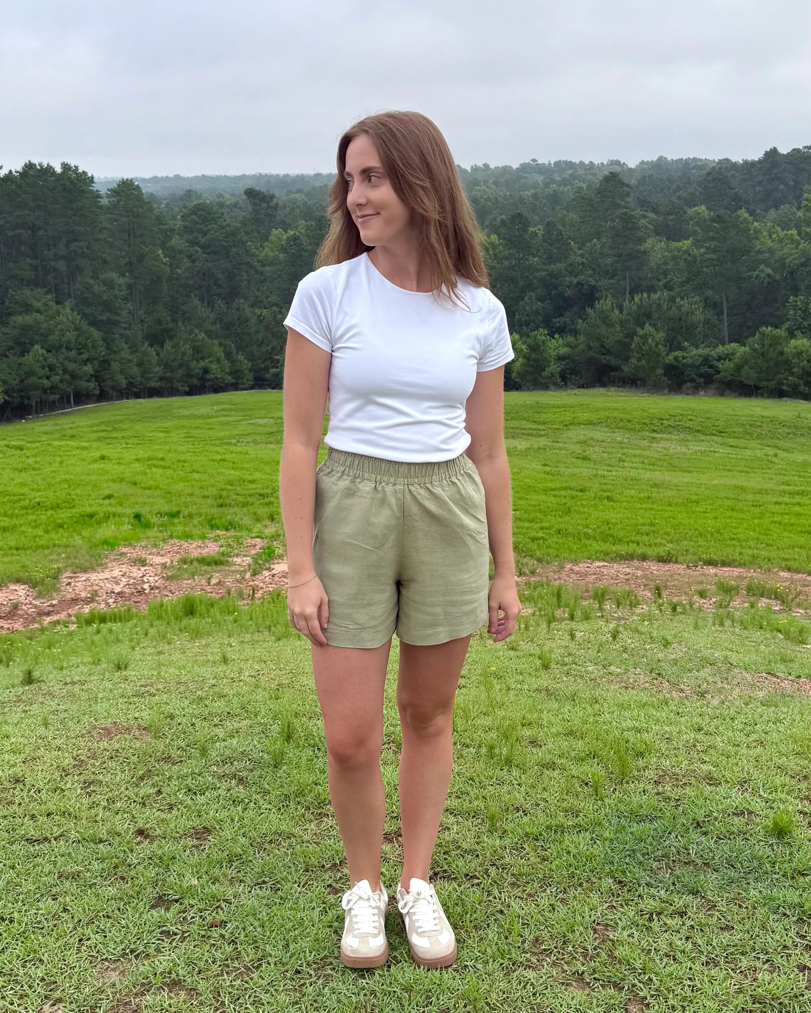Lincoln Paris sage linen shorts displayed on a model, showcasing lightweight, breathable fabric and relaxed fit for casual summer wear.