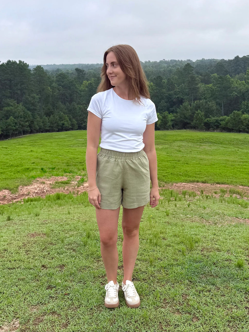 Lincoln Paris sage linen shorts displayed on a model, showcasing lightweight, breathable fabric and relaxed fit for casual summer wear.