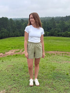 Lincoln Paris sage linen shorts displayed on a model, showcasing lightweight, breathable fabric and relaxed fit for casual summer wear.