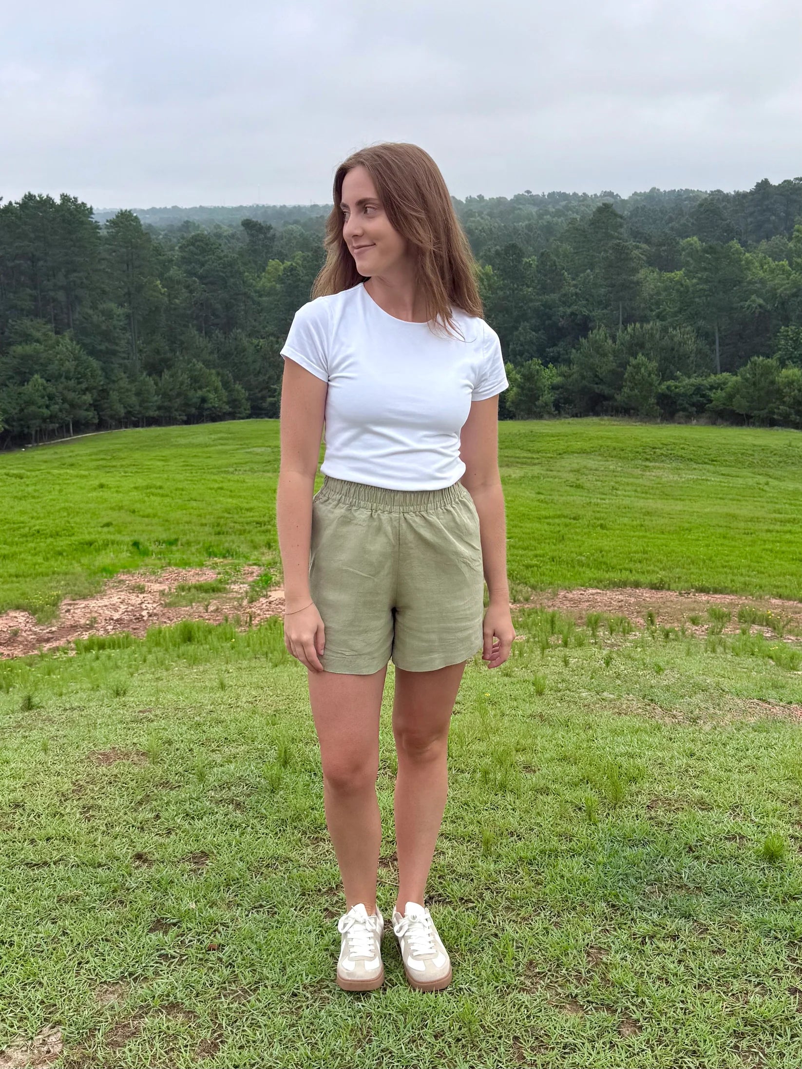 Lincoln Paris sage linen shorts displayed on a model, showcasing lightweight, breathable fabric and relaxed fit for casual summer wear.