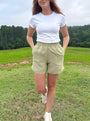 Lincoln Paris sage linen shorts laid flat showing elastic waistband and relaxed fit, perfect for casual summer wear.