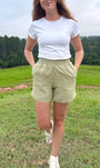 Lincoln Paris sage linen shorts laid flat showing elastic waistband and relaxed fit, perfect for casual summer wear.