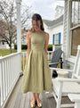 Lincoln Paris Sage Linen Dress displayed on a hanger with a flowing, lightweight fabric and subtle texture.