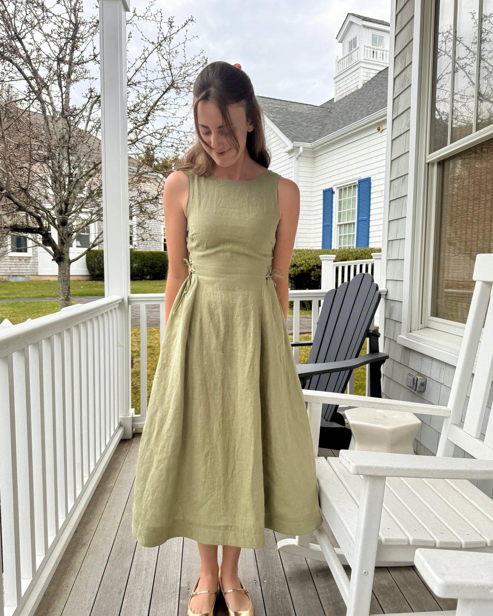 Lincoln Paris Sage Linen Dress displayed on a hanger with a flowing, lightweight fabric and subtle texture.