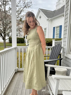 Lincoln Paris Sage linen dress displayed on a hanger with a flowing, lightweight fabric, ideal for casual and summer wear.