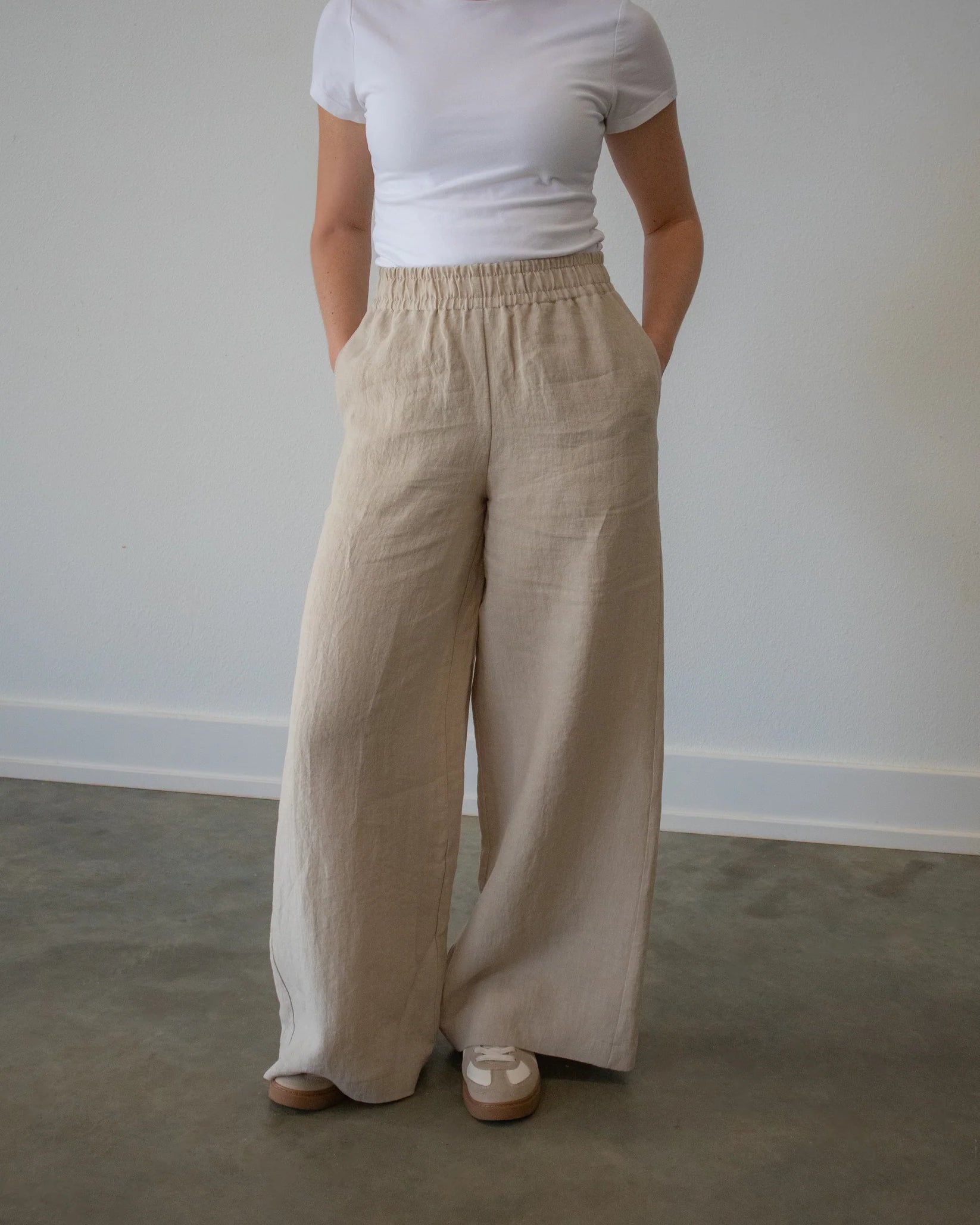 Lincoln Paris Linen Ease Pants, lightweight beige linen trousers with a relaxed fit and side pockets, displayed flat.