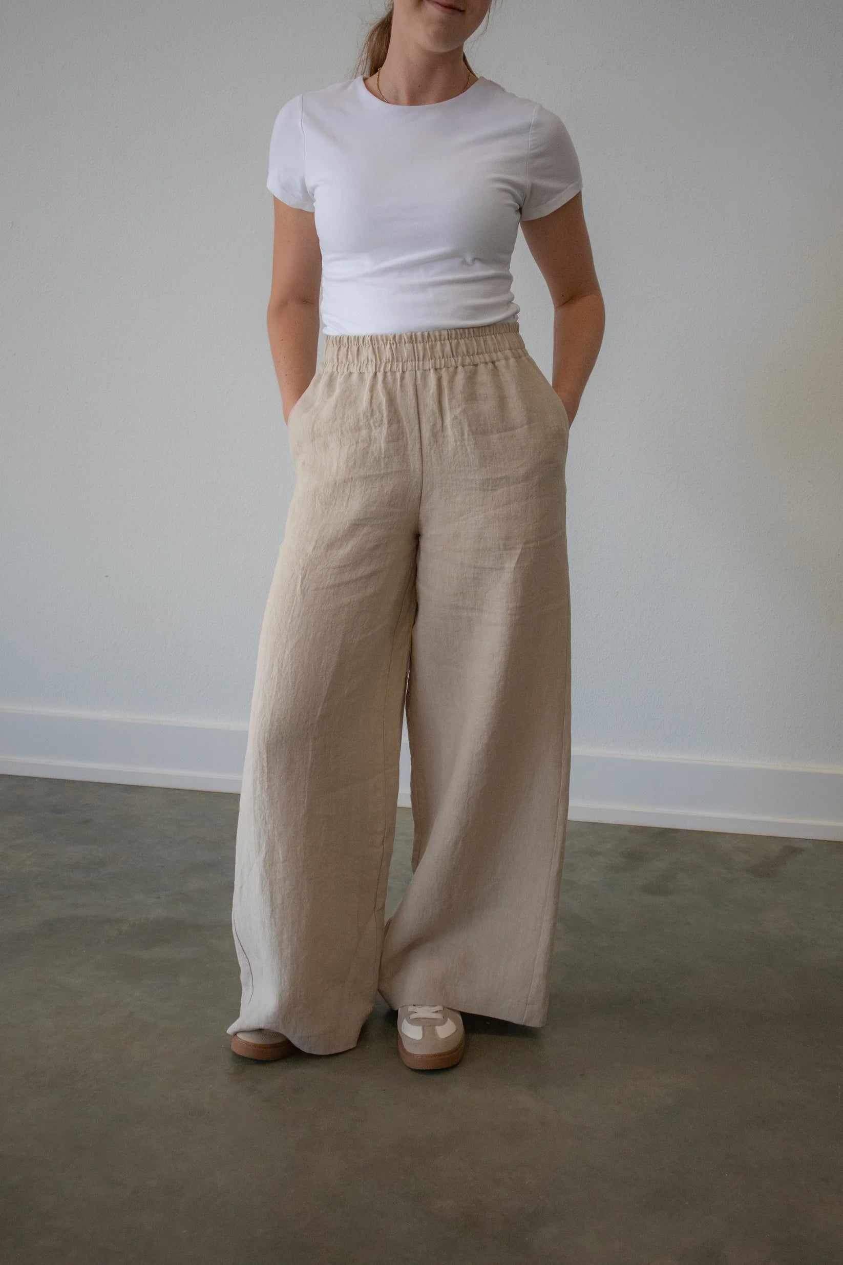 Lincoln Paris Linen Ease Pants, lightweight beige linen trousers with a relaxed fit and side pockets, displayed flat.