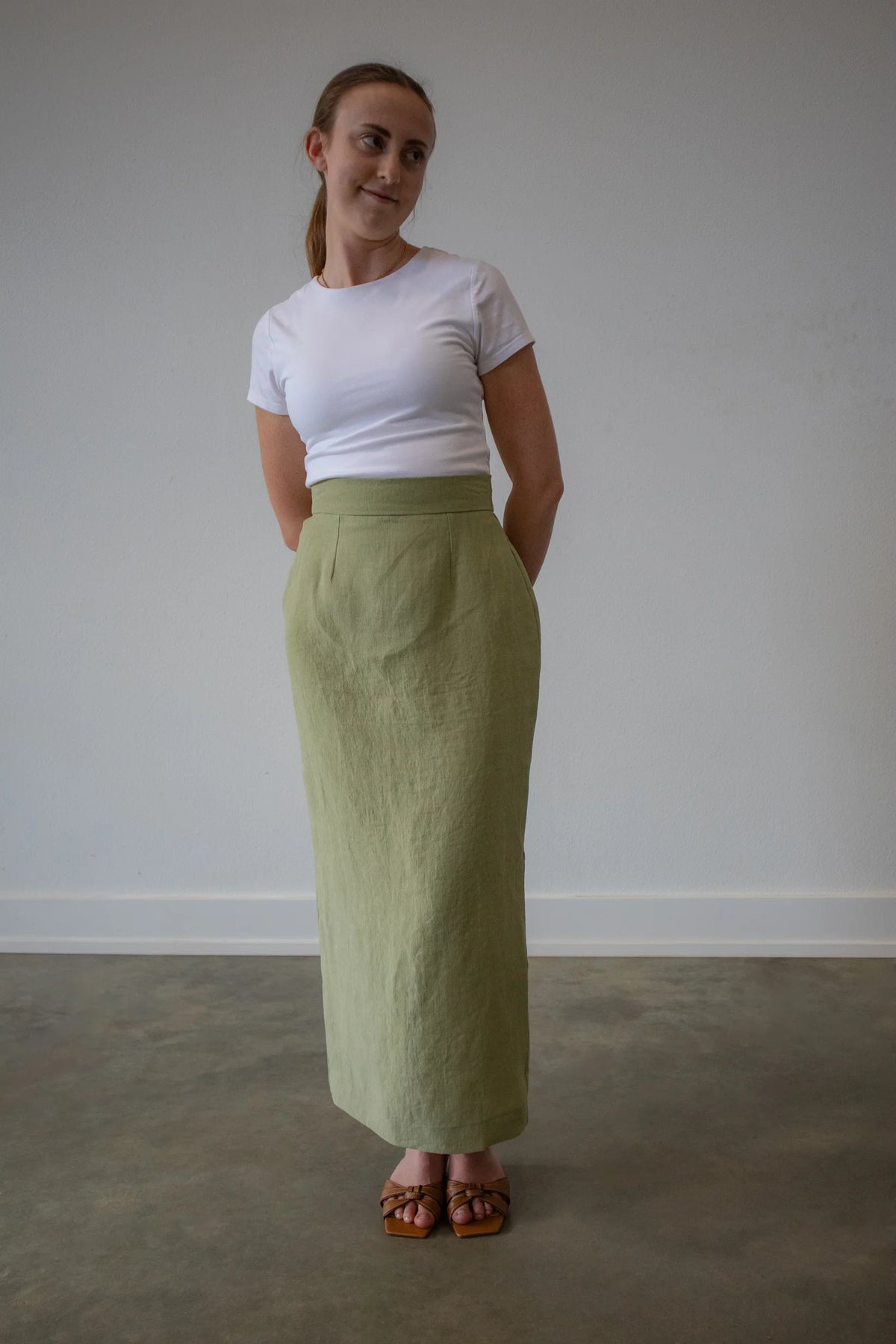 Lincoln Paris Linen Muse Skirt in natural linen fabric, featuring a flowy design and tailored fit, shown on a model.