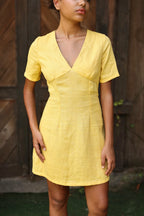 Lincoln Paris DaisyDay cotton linen dress shown on a hanger, featuring a flowy, lightweight fabric with a floral pattern.