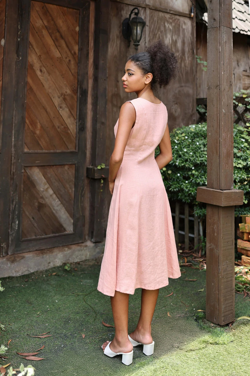Lincoln Paris Roselle cotton linen dress displayed on a hanger with a flowing, lightweight design and natural fabric texture.