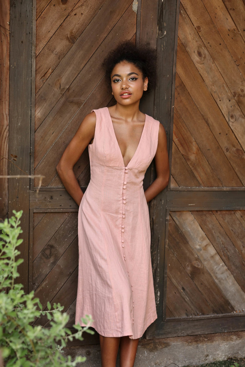Lincoln Paris Roselle cotton linen dress hanging on a wooden hanger, showcasing lightweight, breathable fabric and stylish design.