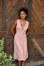 Lincoln Paris Roselle cotton linen dress hanging on a wooden hanger, showcasing lightweight, breathable fabric and stylish design.