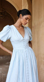 European cotton linen dress by Lincoln Paris, showing a flowy white dress with a relaxed fit and natural fabric texture.