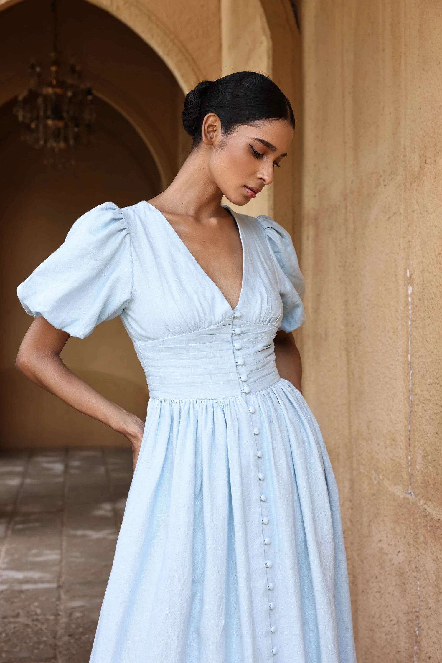 European cotton linen dress by Lincoln Paris, showing a flowy white dress with a relaxed fit and natural fabric texture.