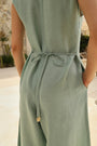 Lincoln Paris Mintleaf cotton linen jumpsuit displayed on a hanger with a fitted waist and wide-leg design.