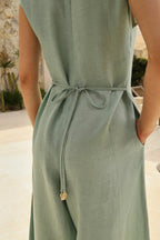 Lincoln Paris Mintleaf cotton linen jumpsuit displayed on a hanger with a fitted waist and wide-leg design.
