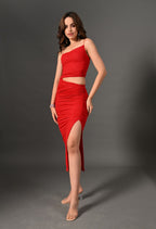 Woman in a red one-shoulder crop top and ruched high-slit skirt set, fashion studio shot